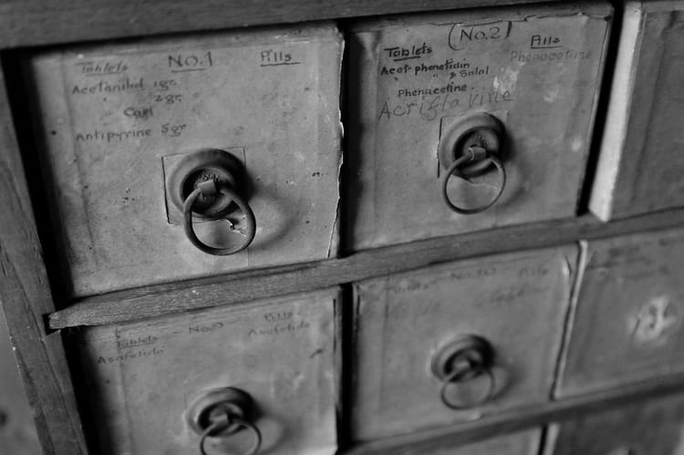 Close-up of vintage filing cabinet drawers with handwritten labels, symbolizing how Notion organizes data and documents in a structured system.